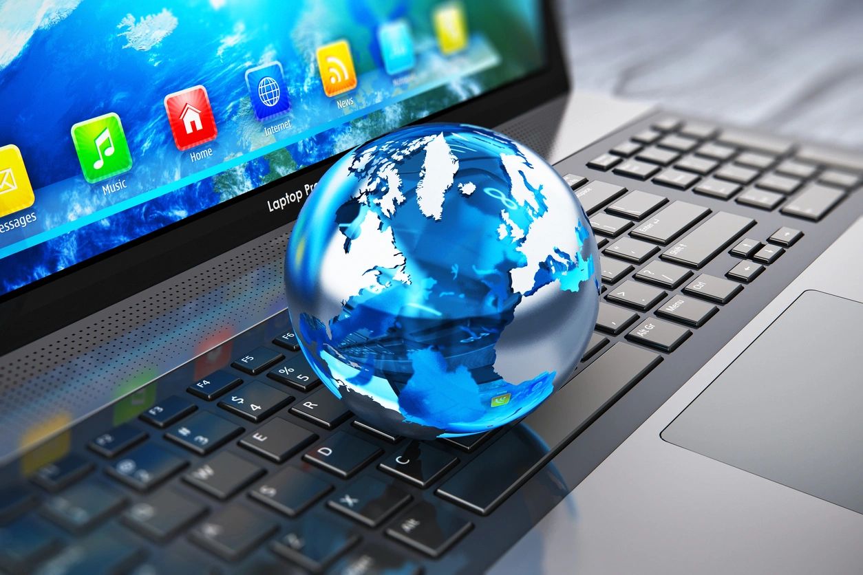 A globe on top of a laptop